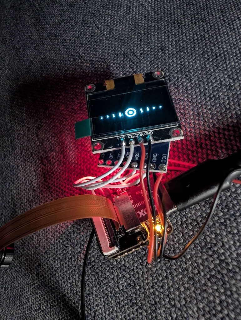 An OLED display and microcontroller wired up on the bench